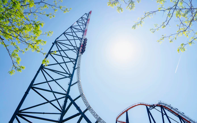 Roller coaster ascent at Top Thrill, Cedar Point against clear sky.