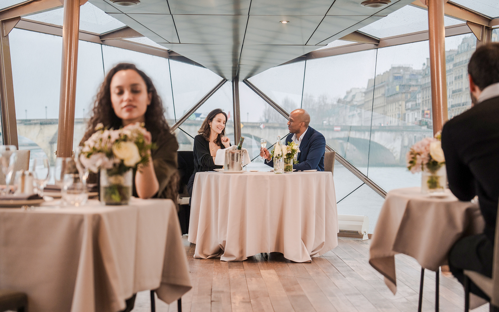 Couple dining on Seine River sightseeing lunch cruise in Paris.