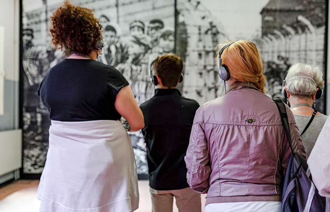 Auschwitz Birkenau guided tour visitors walking through the Auschwitz Birkenau Memorial Museum.