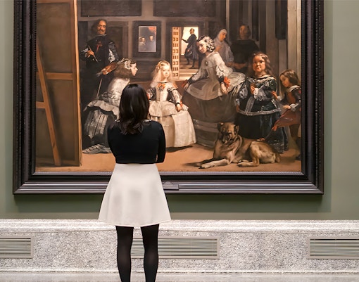 Visitor admiring Velázquez's "Las Meninas" at the Prado Museum in Madrid.