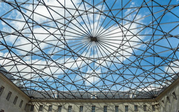 Skylight view inside The Maritime Museum, Amsterdam, showcasing geometric glass roof.