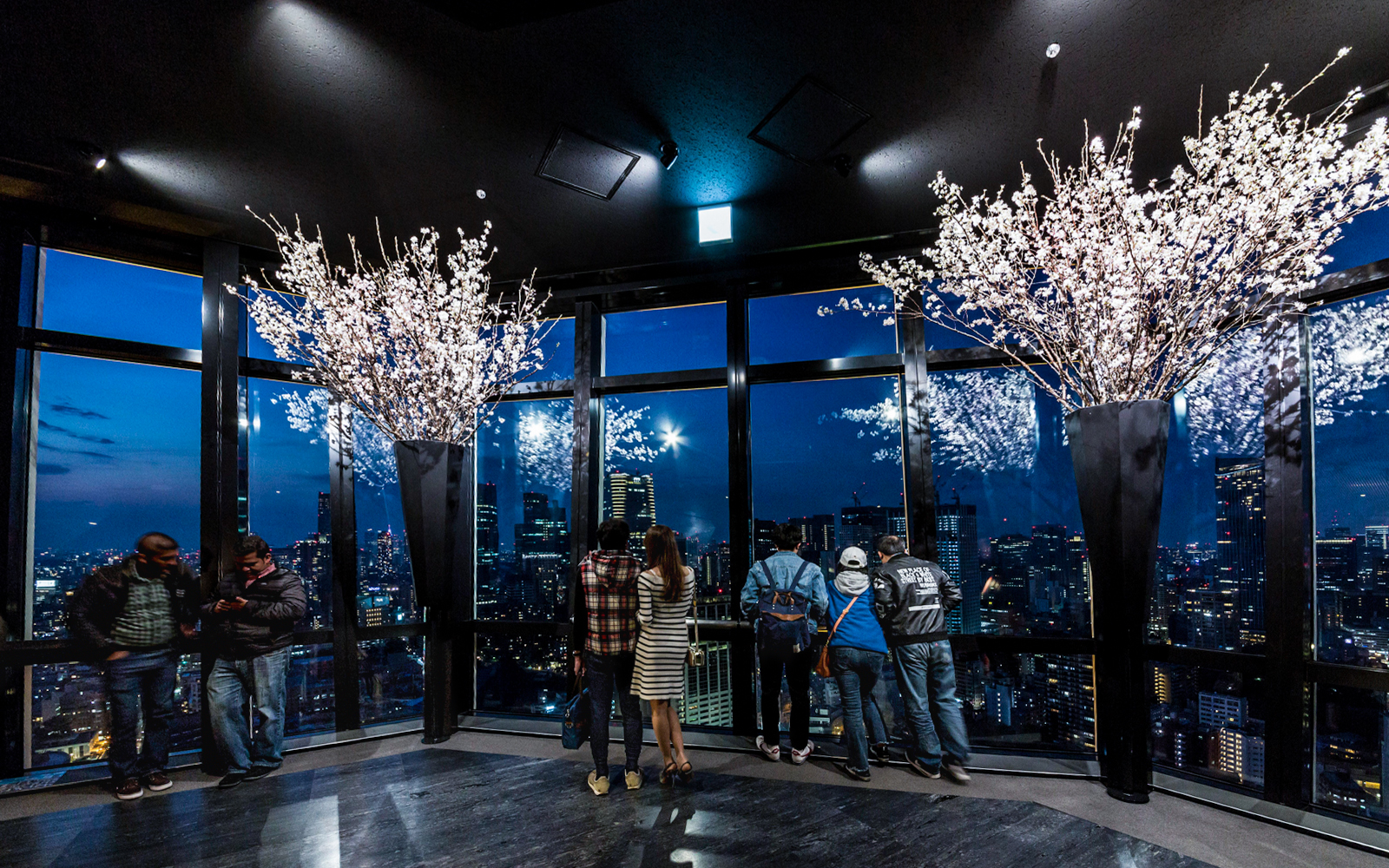 Visitors enjoying the night view of Tokyo skyline from Tokyo Tower Main Deck.