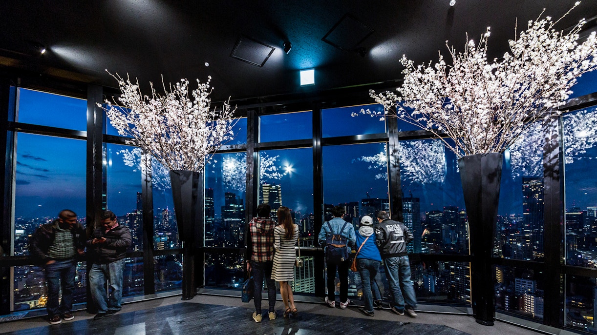 Visitors enjoying the night view of Tokyo skyline from Tokyo Tower Main Deck.