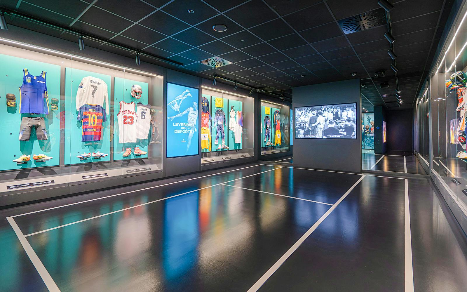 Sports memorabilia display at Rafa Nadal Museum featuring jerseys and equipment.