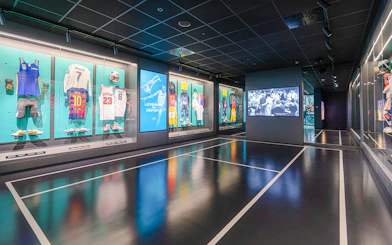 Sports memorabilia display at Rafa Nadal Museum featuring jerseys and equipment.