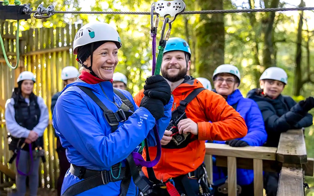Participants preparing for Rotorua Forest zipline tour in safety gear.