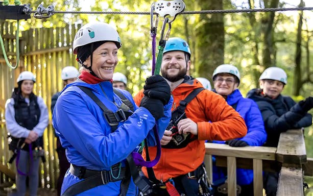 Participants preparing for Rotorua Forest zipline tour in safety gear.