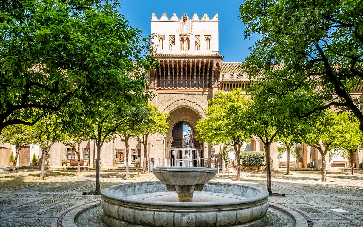 Courtyard with fountain and orange trees at Cathedral and Giralda Tower, Seville.