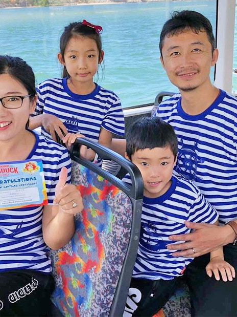Family on Aquaduck tour holding certificate, Sunshine Coast water view.