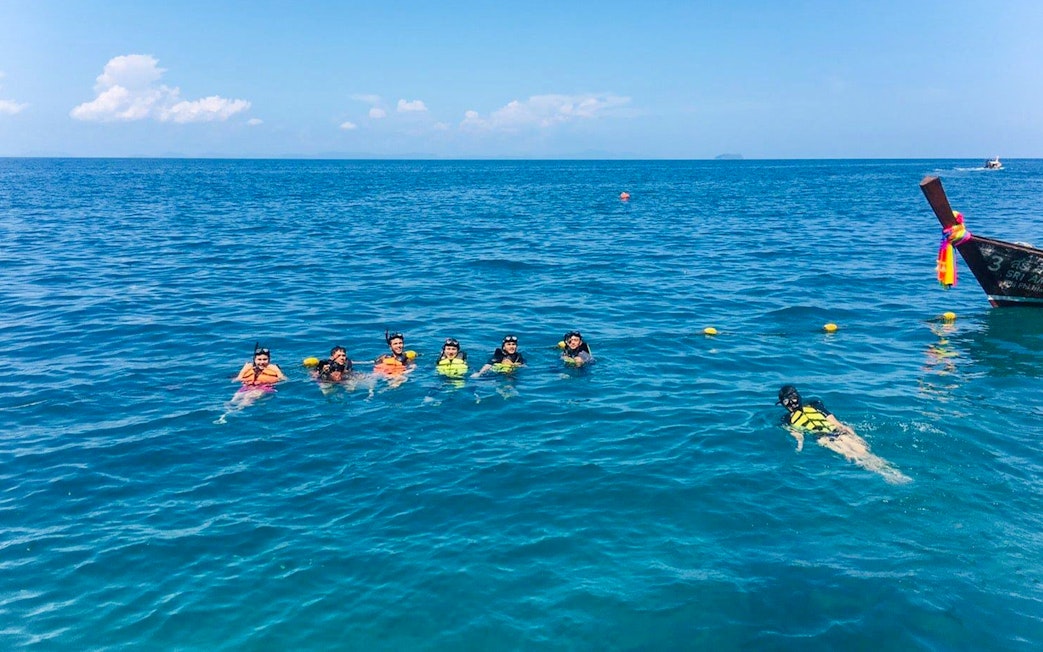 Group snorkeling in clear water near Bamboo Island, Phi Phi tour.