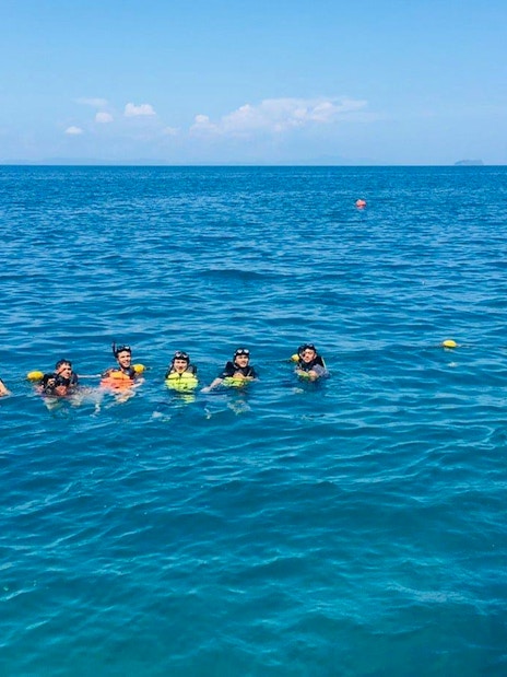 Group snorkeling in clear water near Bamboo Island, Phi Phi tour.