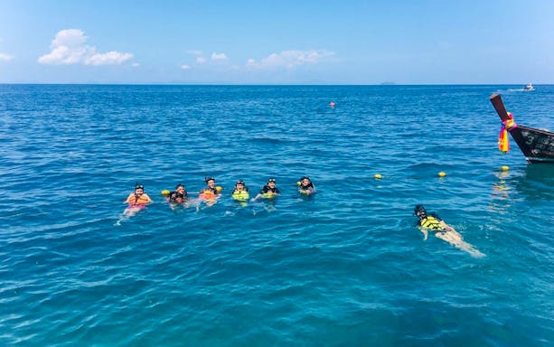 Group snorkeling in clear water near Bamboo Island, Phi Phi tour.