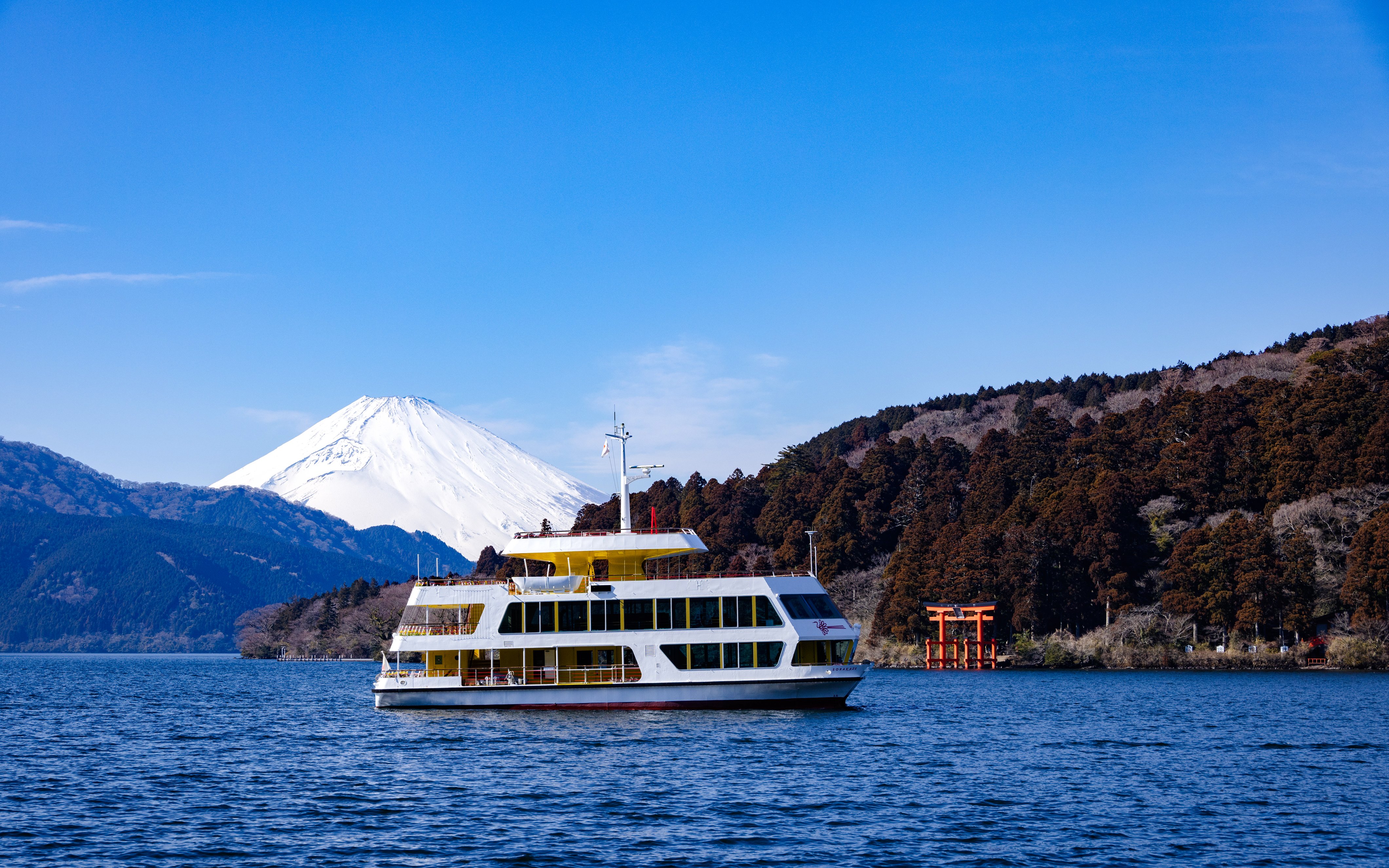 Hakone sightseeing cruise on Lake Ashi with Mount Fuji and torii gate in the background.