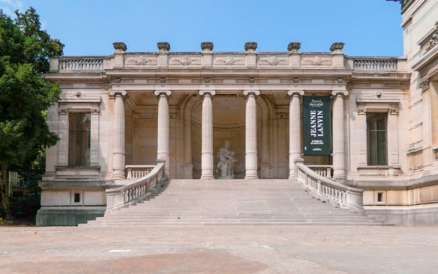 Palais Galliera exterior with grand staircase and columns in Paris, France.