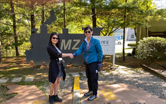 Visitors shaking hands at DMZ Third Tunnel entrance, South Korea.