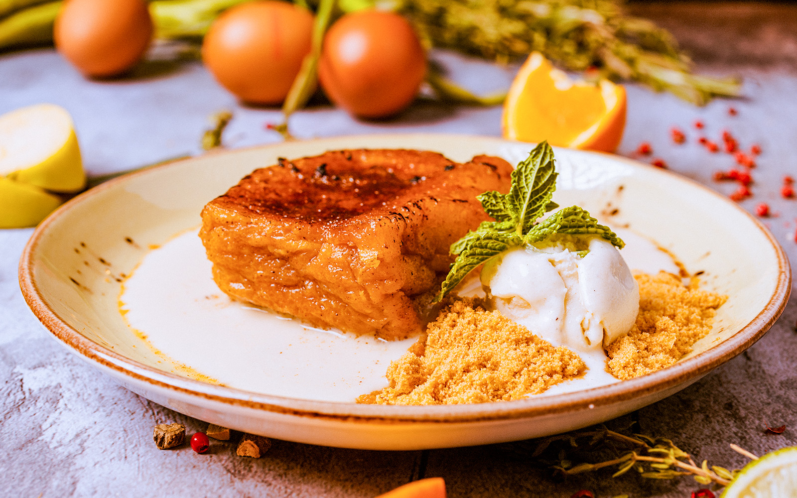 Torrijas dessert with ice cream and mint garnish on a plate.