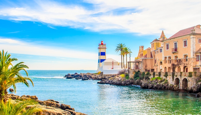 Cascais coastline with Santa Marta Lighthouse and historic buildings, Portugal.