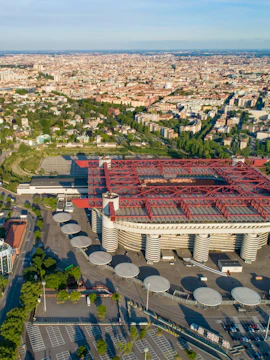 Aerial view of Milan featuring San Siro Stadium and surrounding cityscape.