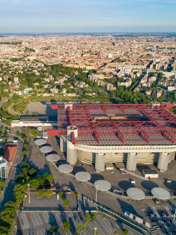 Aerial view of Milan featuring San Siro Stadium and surrounding cityscape.