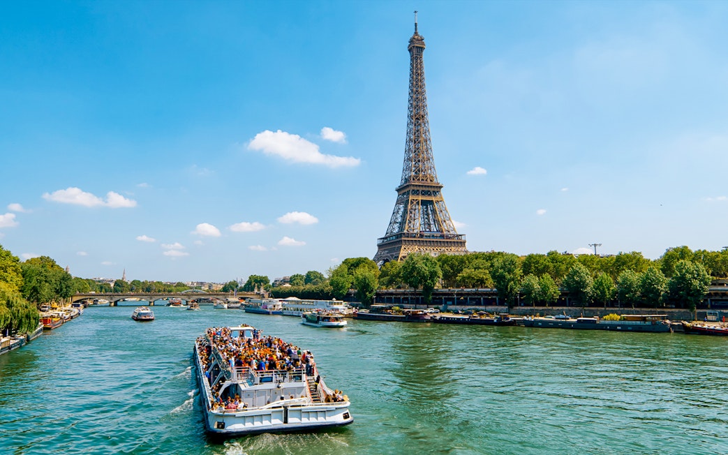 Seine River cruise boat near Eiffel Tower in Paris.