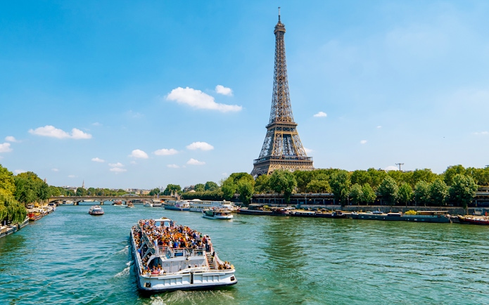 Seine River cruise boat near Eiffel Tower in Paris.