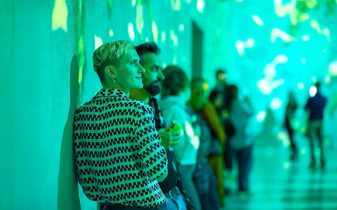 Visitors enjoying immersive light display at Frameless Lates event.