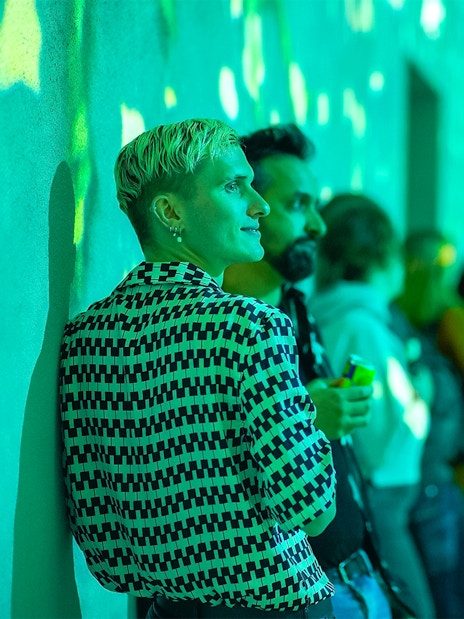 Visitors enjoying immersive light display at Frameless Lates event.