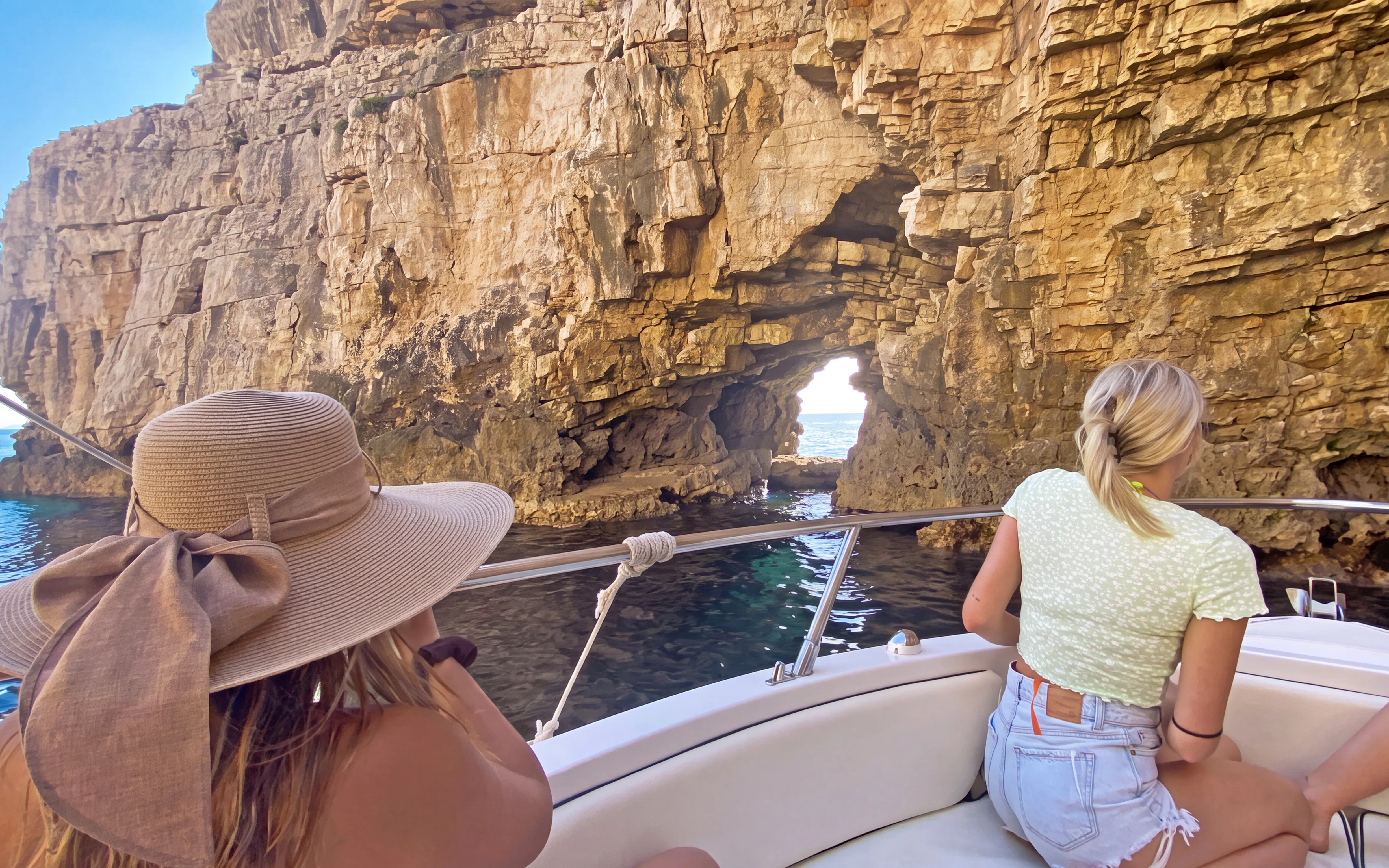 Boat approaching rocky archway on Brijuni Islands tour from Fažana.