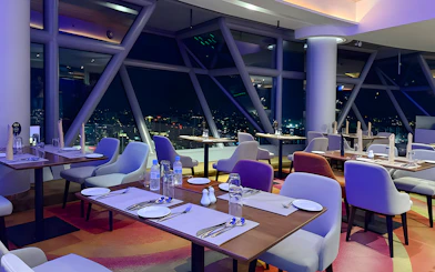 Dining area with city view at Orbit Revolving Restaurant, KL Tower, Kuala Lumpur.