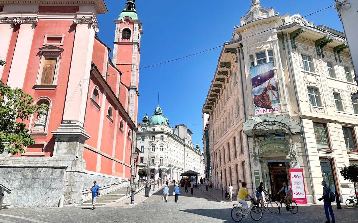 Ljubljana city center with Franciscan Church and Emporium building, part of guided tour from Zagreb.