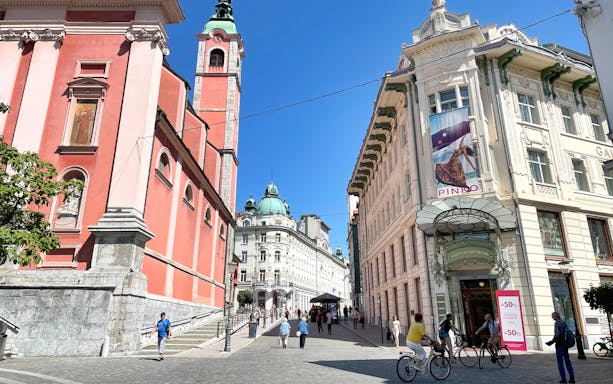 Ljubljana city center with Franciscan Church and Emporium building, part of guided tour from Zagreb.