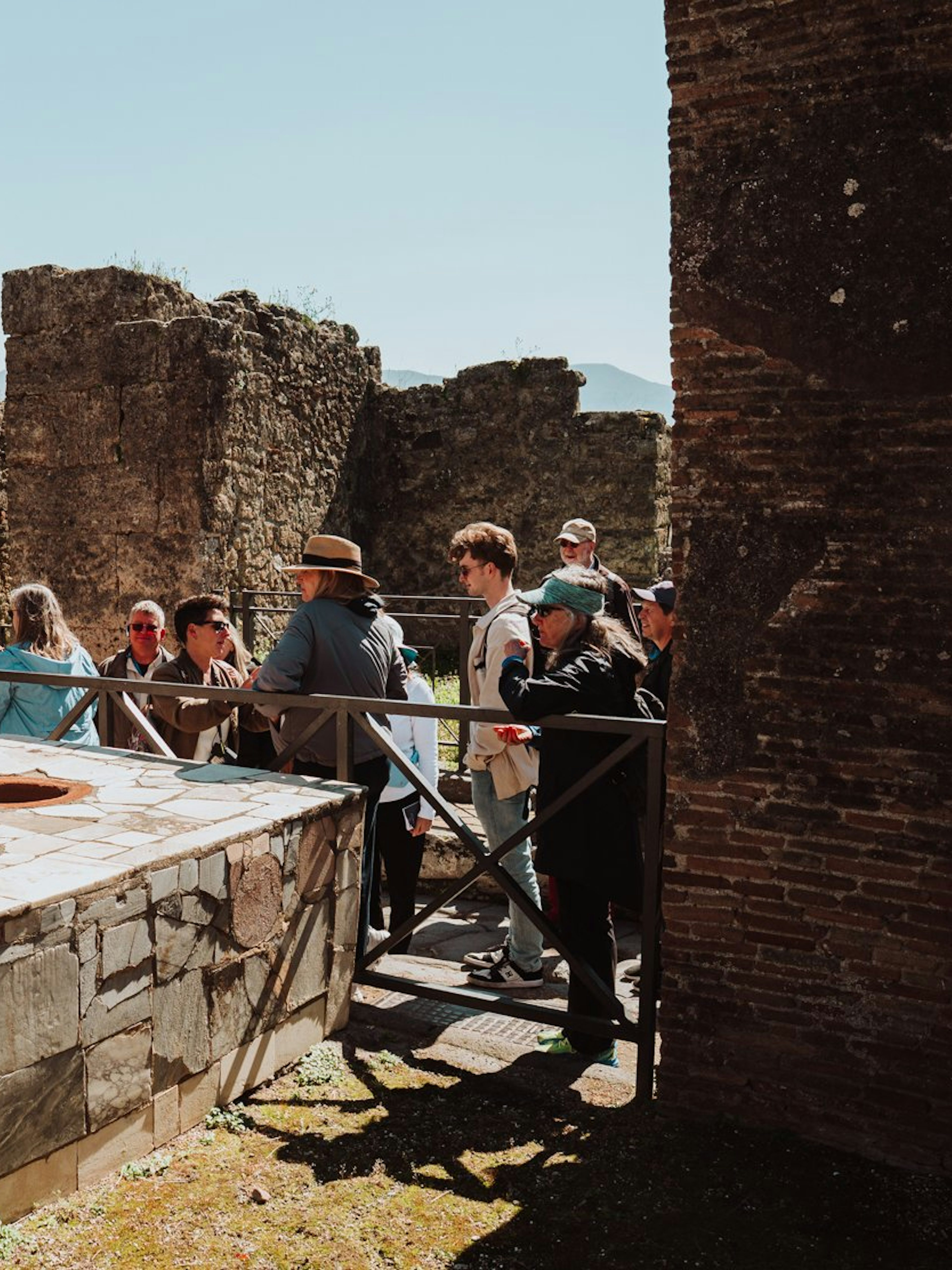 Tour group exploring ancient ruins in Pompeii, Italy.