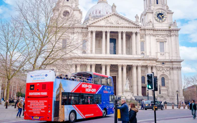 Open-top Golden Tours bus in front of St. Paul's Cathedral, London.