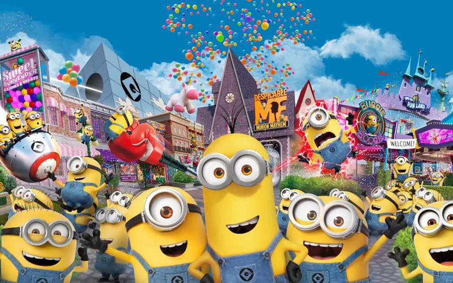 Minions at Universal Studios Singapore's Despicable Me attraction with colorful buildings and balloons.