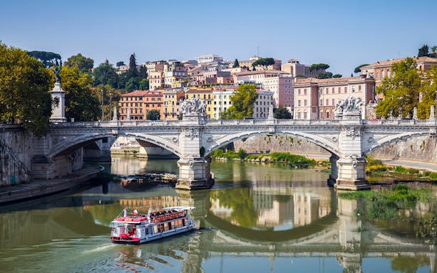 Touristic boat on the Tiber River near Ponte Vittorio Emanuele II, Rome.