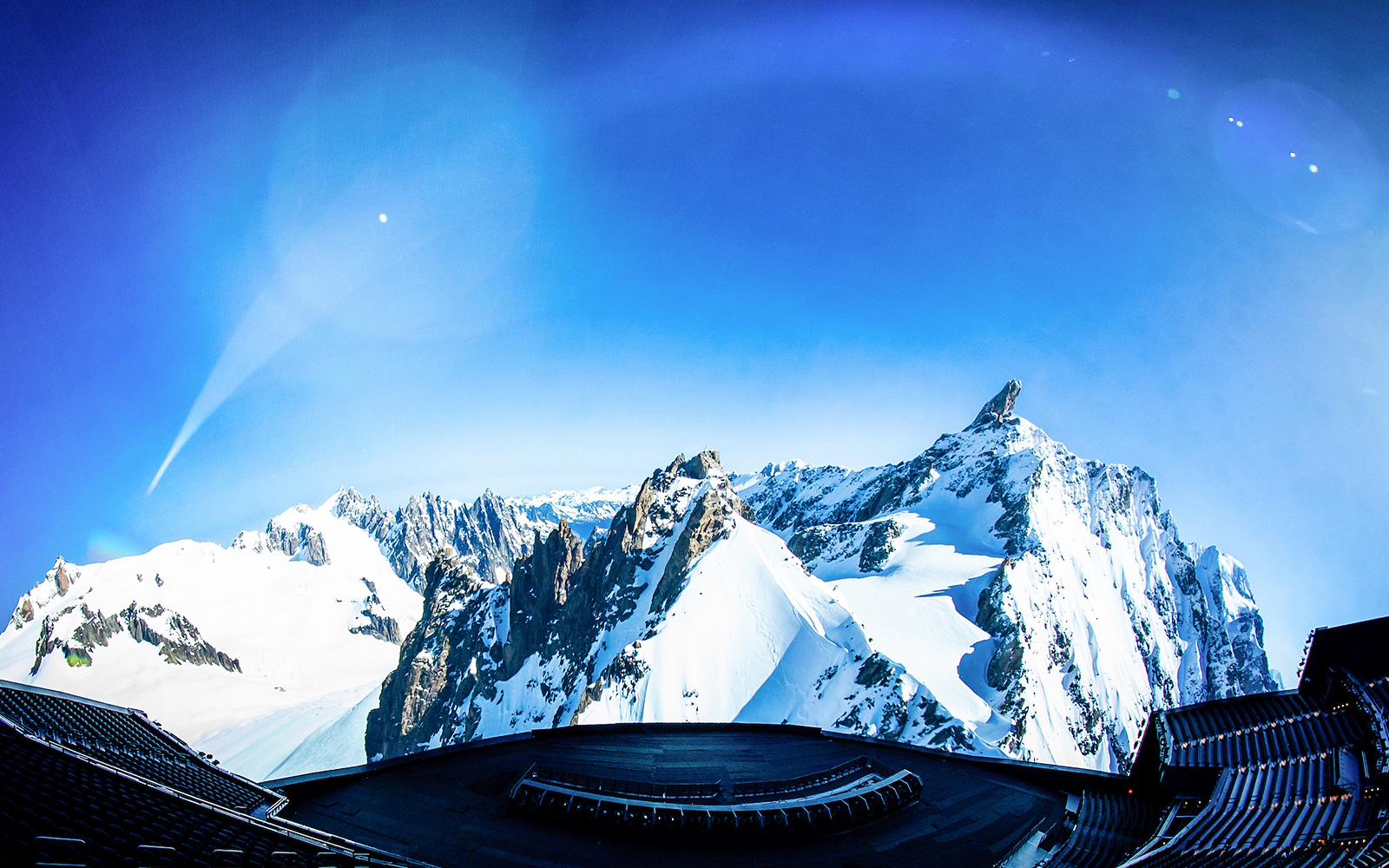 Aerial view of snowy mountains with a futuristic structure in the foreground, Las Vegas.