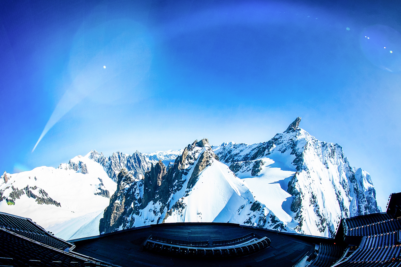 Aerial view of snowy mountains with a futuristic structure in the foreground, Las Vegas.