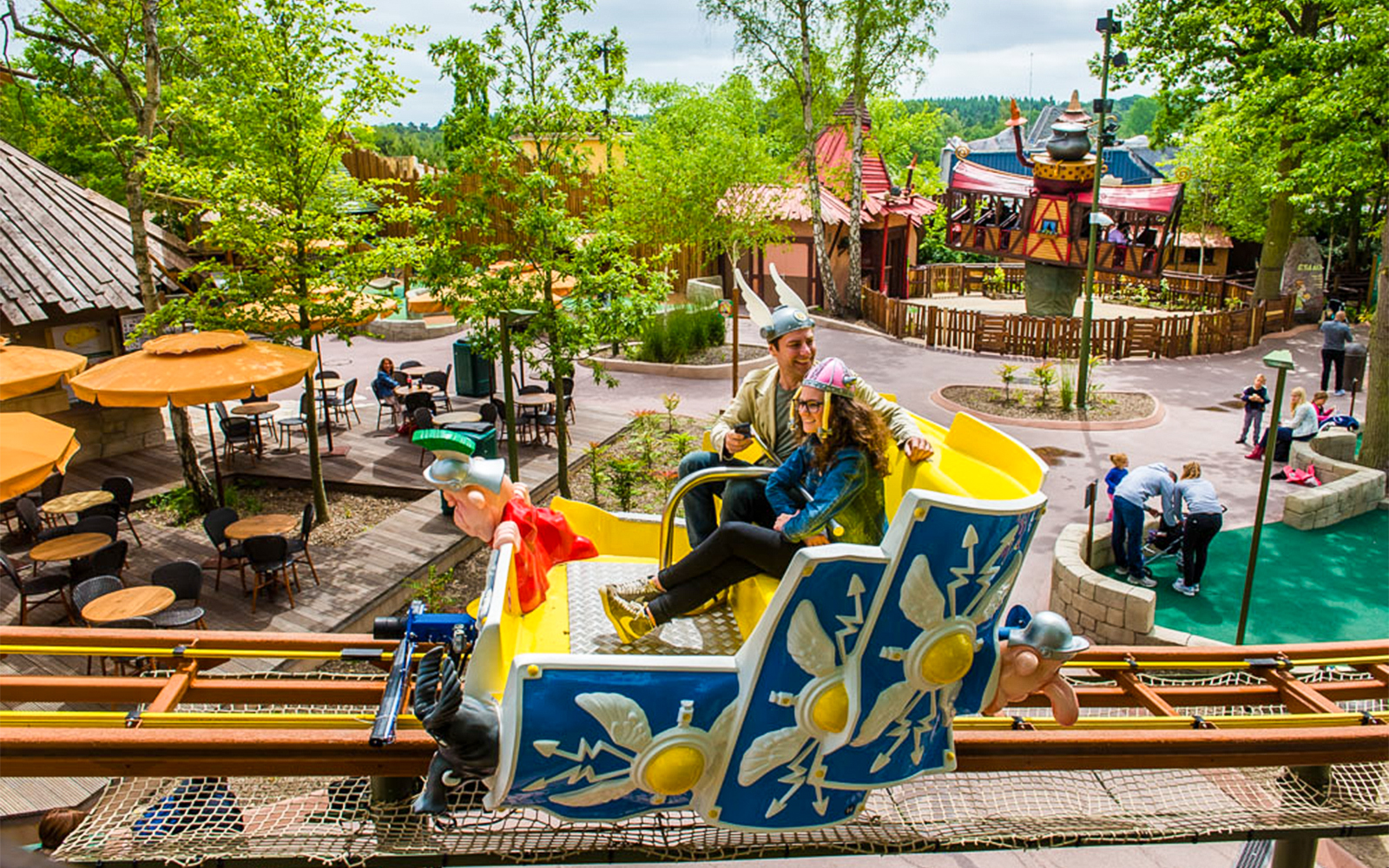 Roller coaster at Parc Asterix, France, with passengers enjoying the thrilling ride.