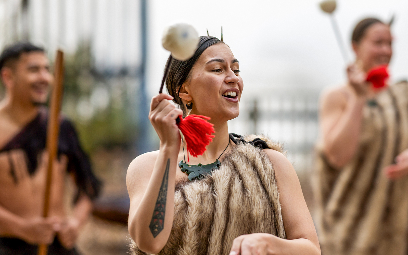 Performer in traditional Māori attire during Te Puia Haka experience, New Zealand.