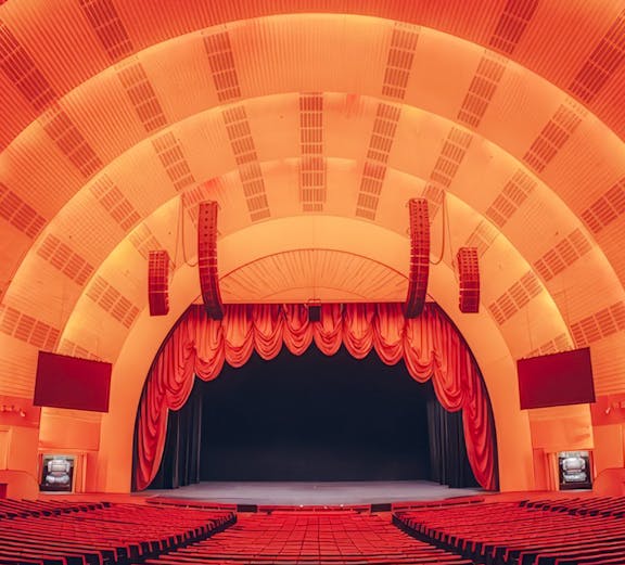 Interior view of Radio City Music Hall auditorium, New York, featuring stage and seating.