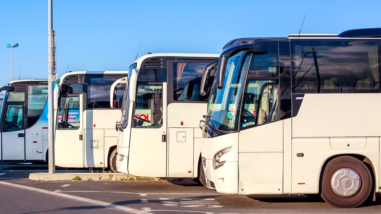 Tour buses parked, ready for Château de Pierrefonds excursion.
