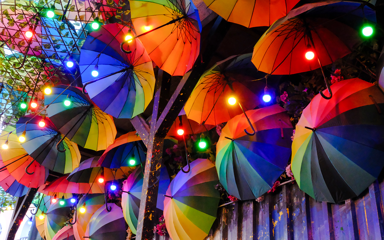 Colorful umbrellas hanging in Karaköy, Istanbul, with vibrant lights.