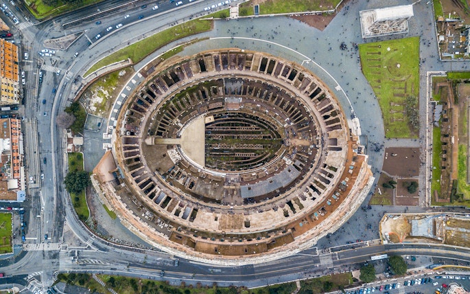 Aerial view of the Colosseum in Rome, Italy, highlighting its ancient architecture.
