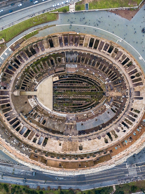 Aerial view of the Colosseum in Rome, Italy, highlighting its ancient architecture.