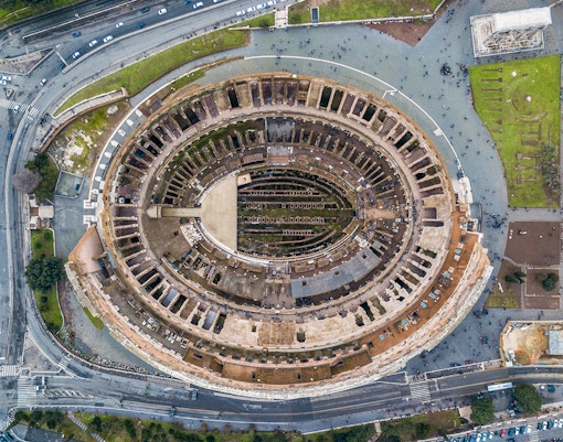 Aerial view of the Colosseum in Rome, Italy, highlighting its ancient architecture.