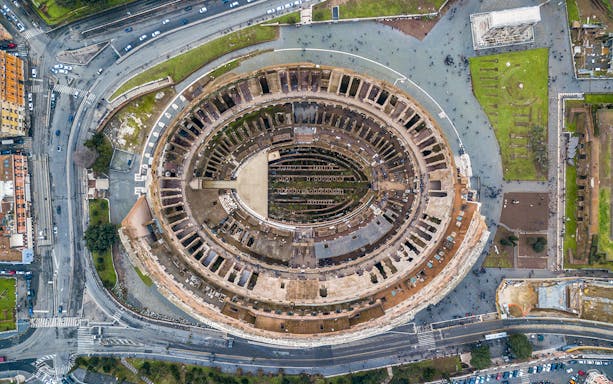 Aerial view of the Colosseum in Rome, Italy, highlighting its ancient architecture.