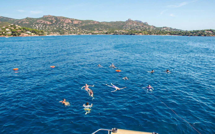 Snorkelers enjoying a catamaran cruise in Villefranche Bay, France.