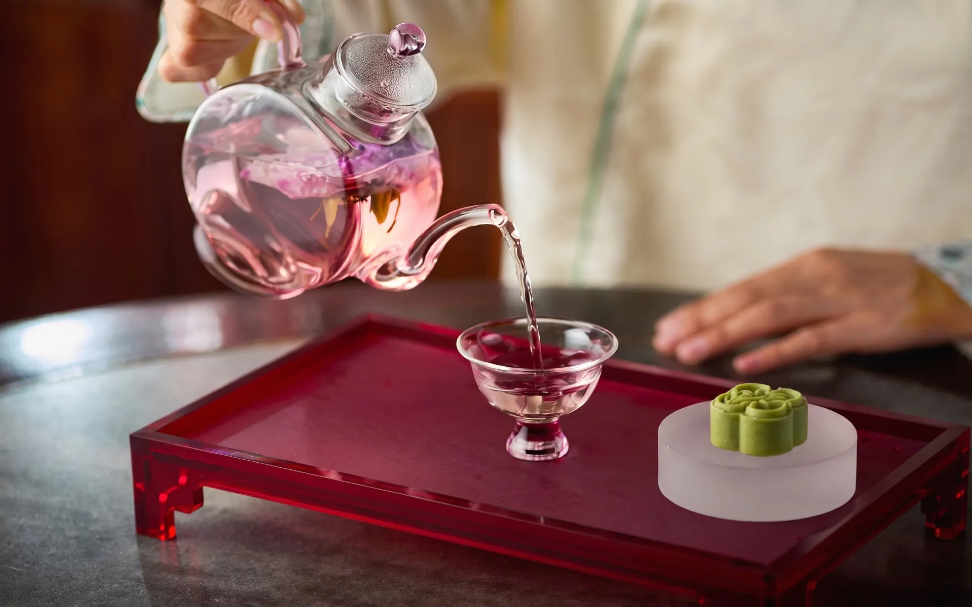 Pouring tea into a glass cup at Yu Garden Huxinting Teahouse, Shanghai.