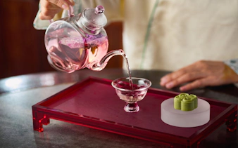Pouring tea into a glass cup at Yu Garden Huxinting Teahouse, Shanghai.