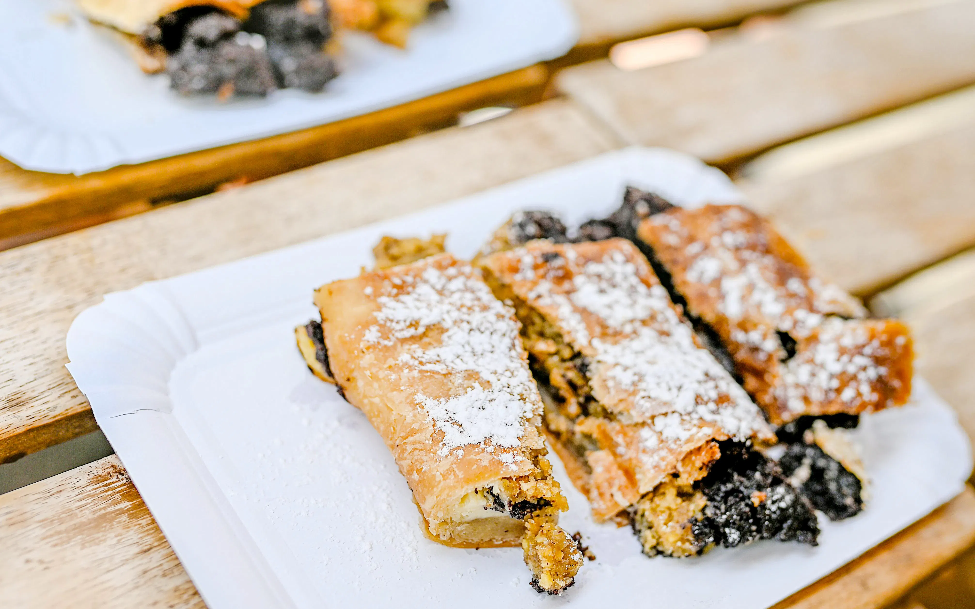 Czech pastry with poppy seeds on a plate during Prague food tour.